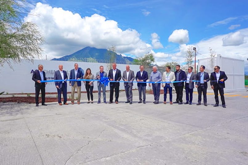 A photo from the opening. Staff members cut a blue ribbon.