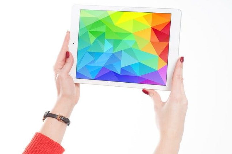 A tablet with a multicoloured display as symbol image.