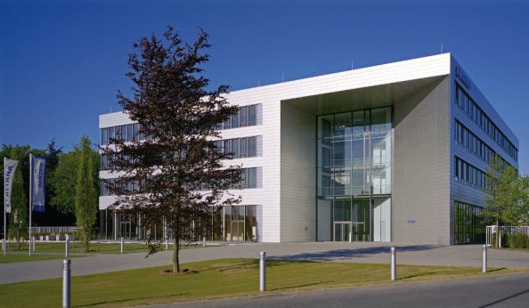 Company building with tree in the foreground.