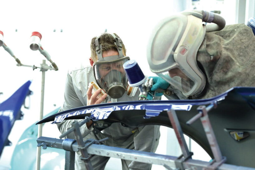 Young car painters at work.