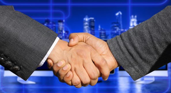 A handshake with business background as symbol.