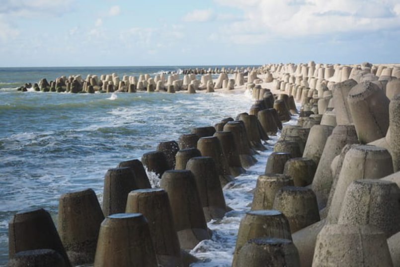 Concrete breakwater as a symbolic image.