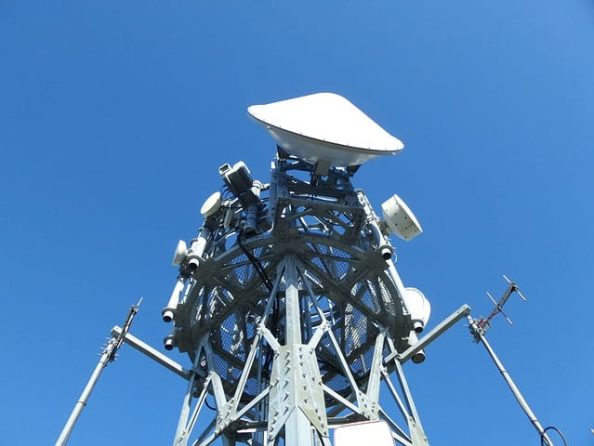 A telecommunications tower with a variety of dish antennas for microwave relay.