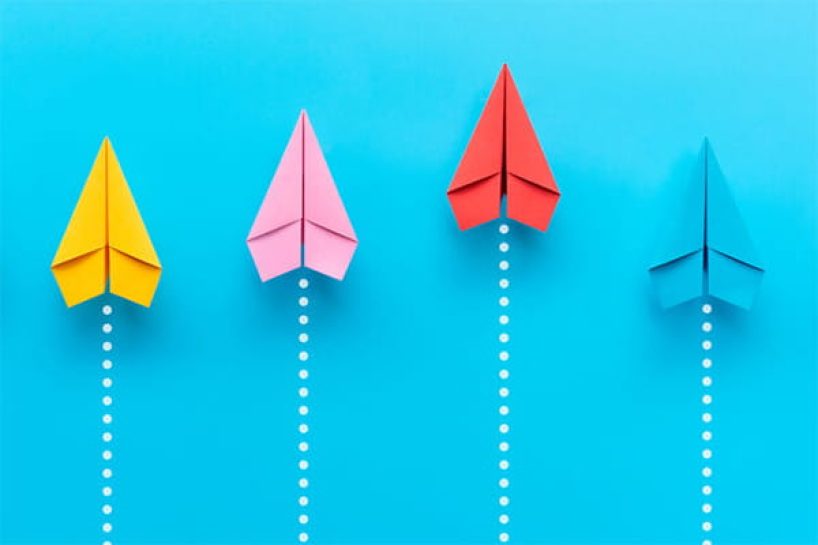 Colourful rising paper planes.