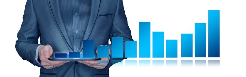 Graphic of a businessman with tablet and bar chart.