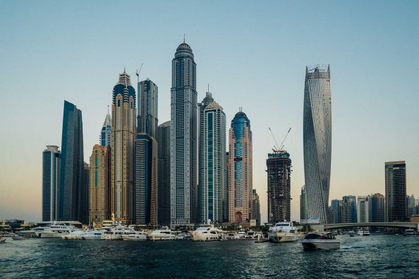 Silhouette of Dubai with skyscrapers and ships.