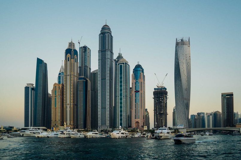 Silhouette of Dubai with skyscrapers and ships.