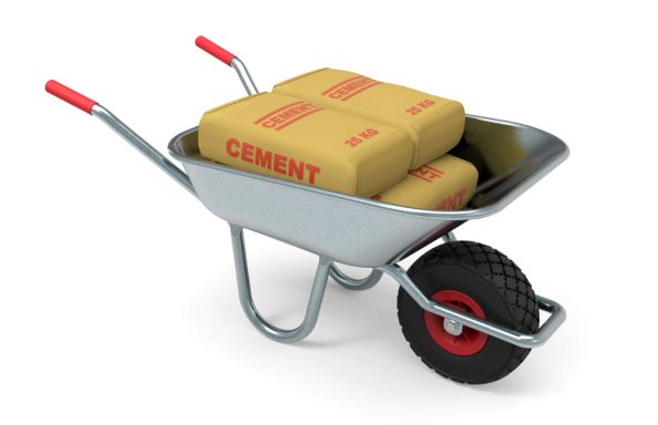 Bags with the inscription cement in a wheelbarrow.