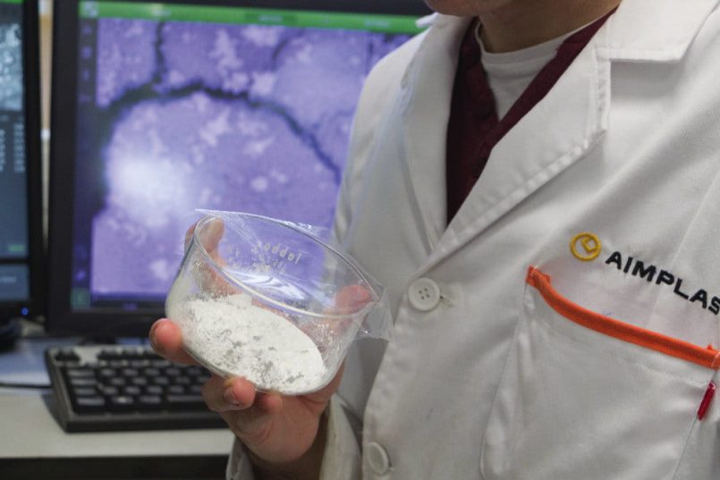 Transparent petri dish with white flakes