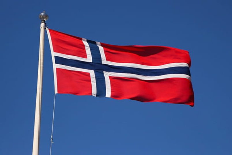 The Norwegian flag against a blue sky.