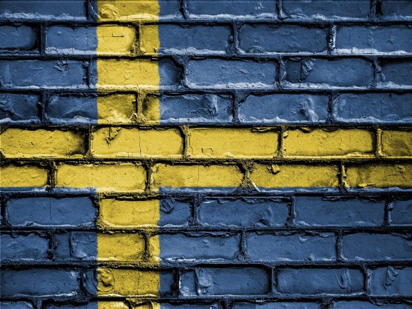 Brick wall painted in the colours of the Swedish national flag.