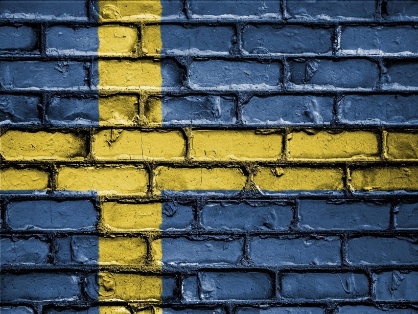 Flag of sweden painted on a brick wall.