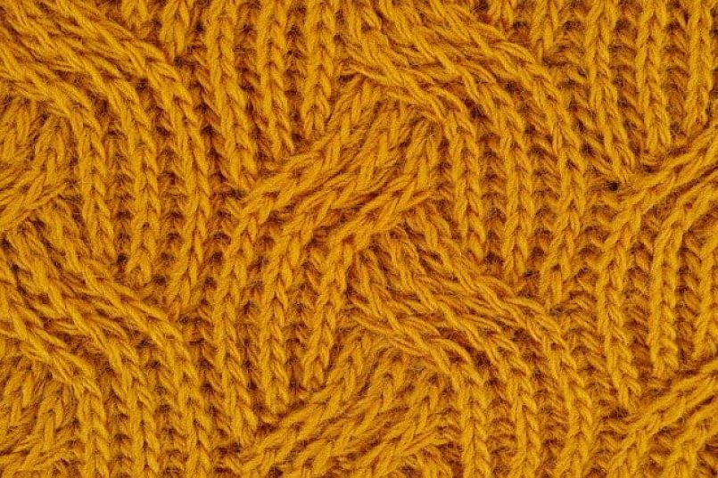 A detailed view of a yellow coloured fabric as a symbol.