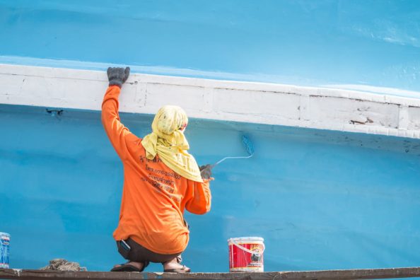 A man painting a vessel as a symbol image.