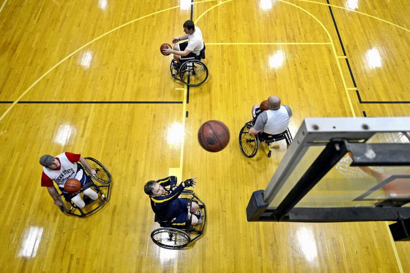 Wheelchair basketball player from above in a gym.