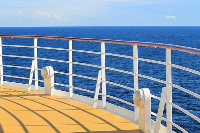 The coated railing of a ship at sea.