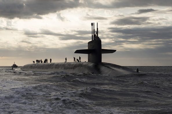 A surfaced submarine in the sunset.