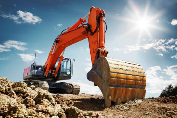 An excavator on a construction site as a symbol.