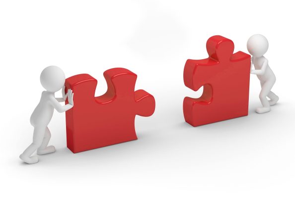 A graphic shows two stilised figures pushing puzzle pieces together.