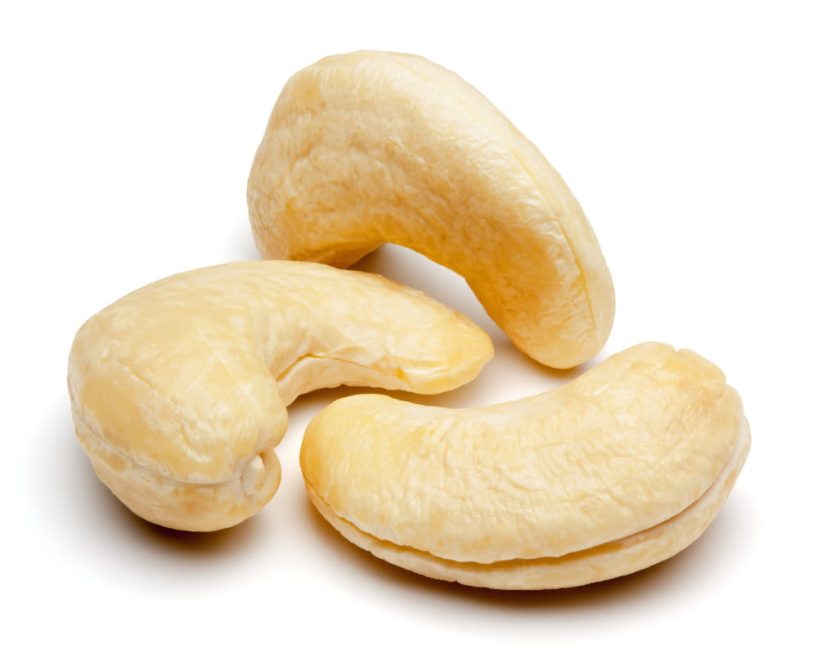 Three cashew nuts on a white background.