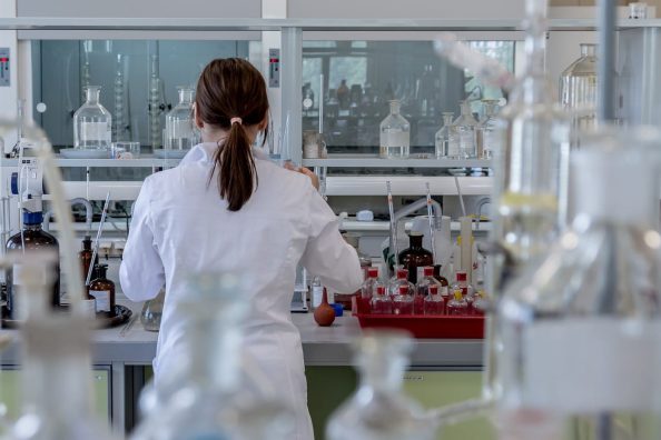 Symbol: Woman in a laboratory with different containers.